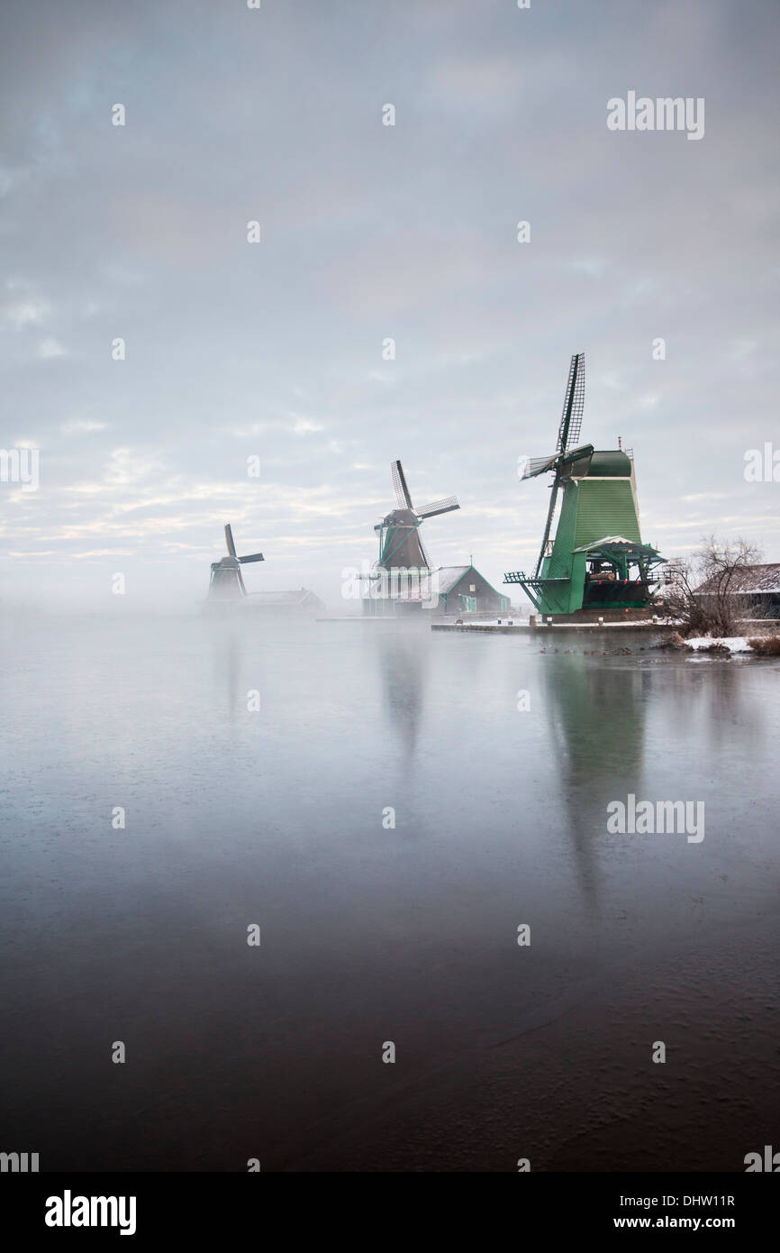 Netherlands, Zaanse Schans near Zaandam, Open air tourist attraction with windmills and houses. Winter Stock Photo