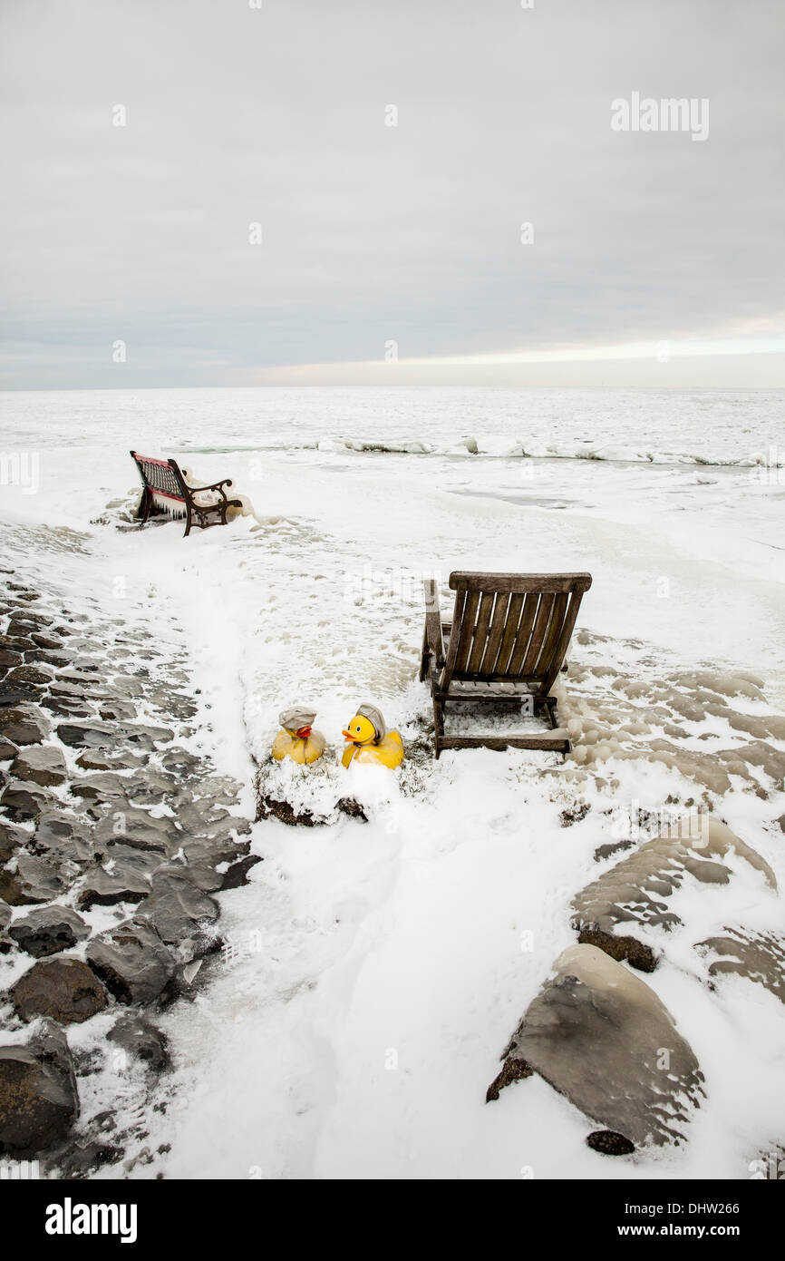 Netherlands, Marken, Lake called IJsselmeer. Winter. Chairs and toy ducks in ice Stock Photo