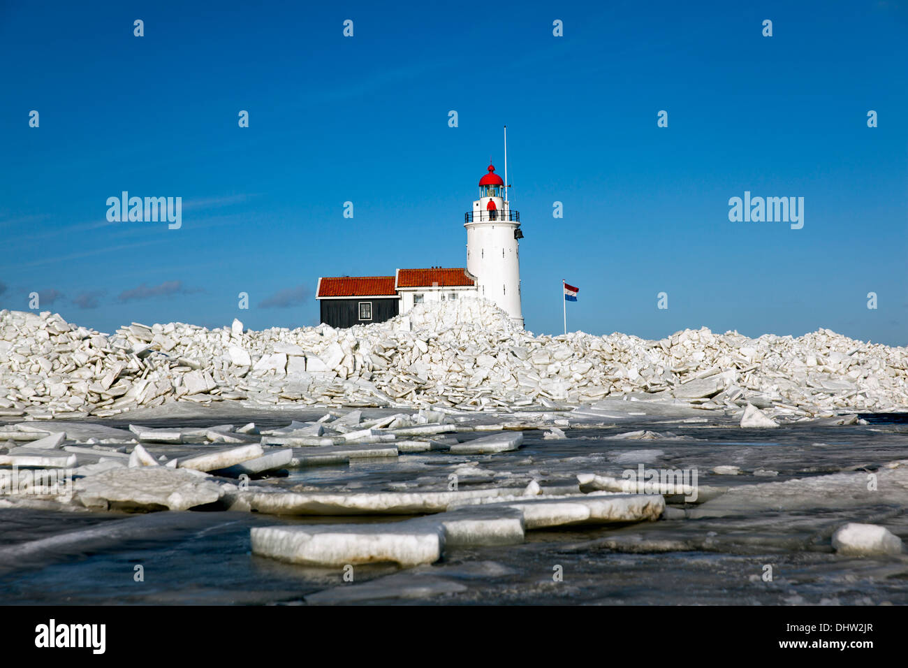 Netherlands, Marken, Lake called IJsselmeer. Winter. Lighthouse called Het Paard. Drifting ice threatening the lighthouse Stock Photo
