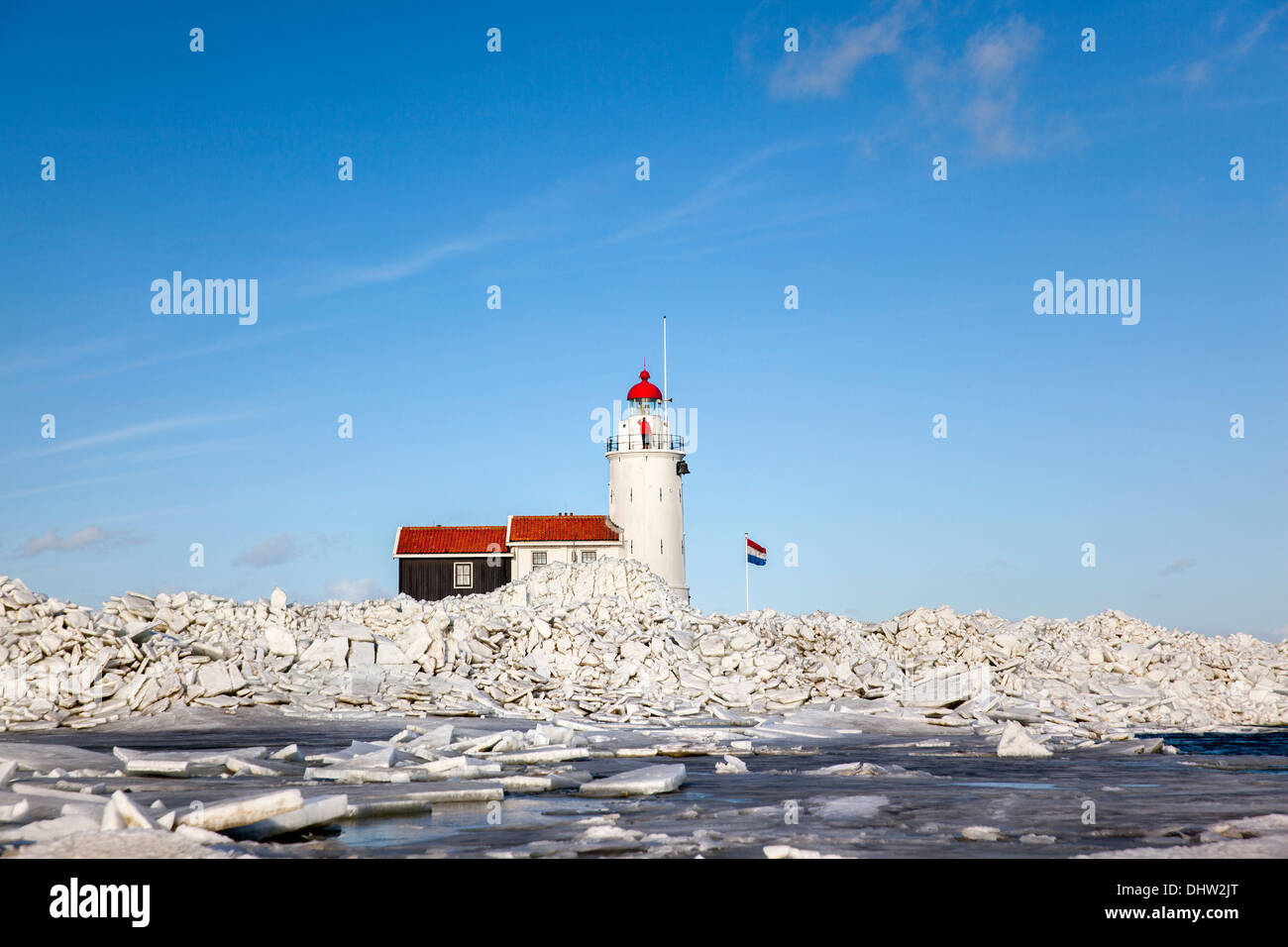 Netherlands, Marken, Lake called IJsselmeer. Winter. Lighthouse called Het Paard. Drifting ice threatening the lighthouse Stock Photo