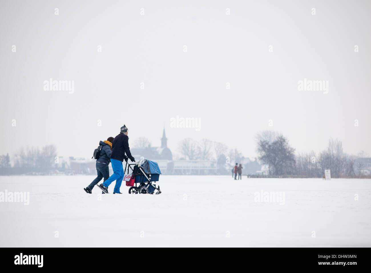 herlands, Loosdrecht, Lakes called Loosdrechtse Plassen. Winter. Family ice skating with buggy Stock Photo