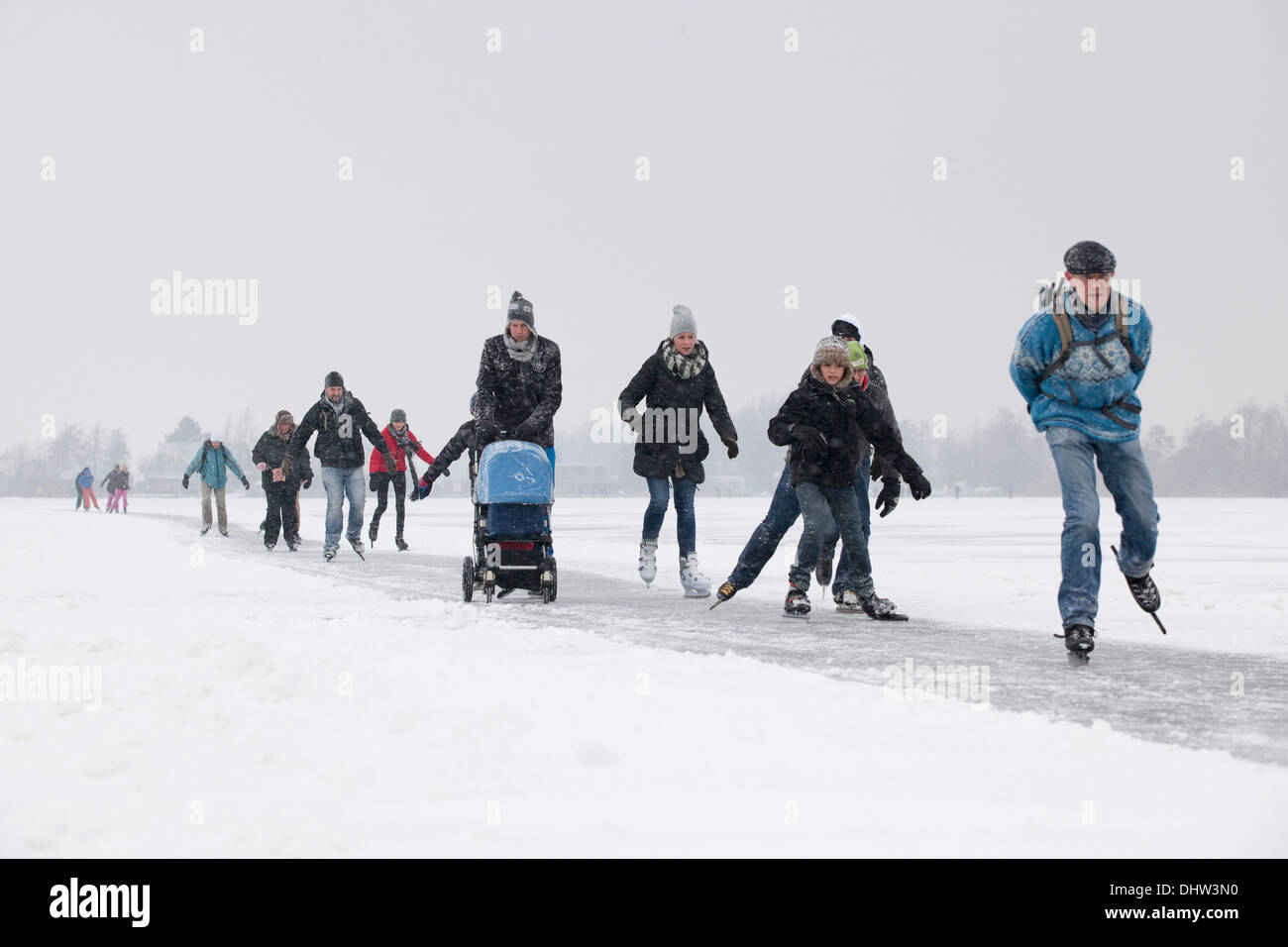 herlands, Loosdrecht, Lakes called Loosdrechtse Plassen. Winter. Family ice skating with buggy Stock Photo