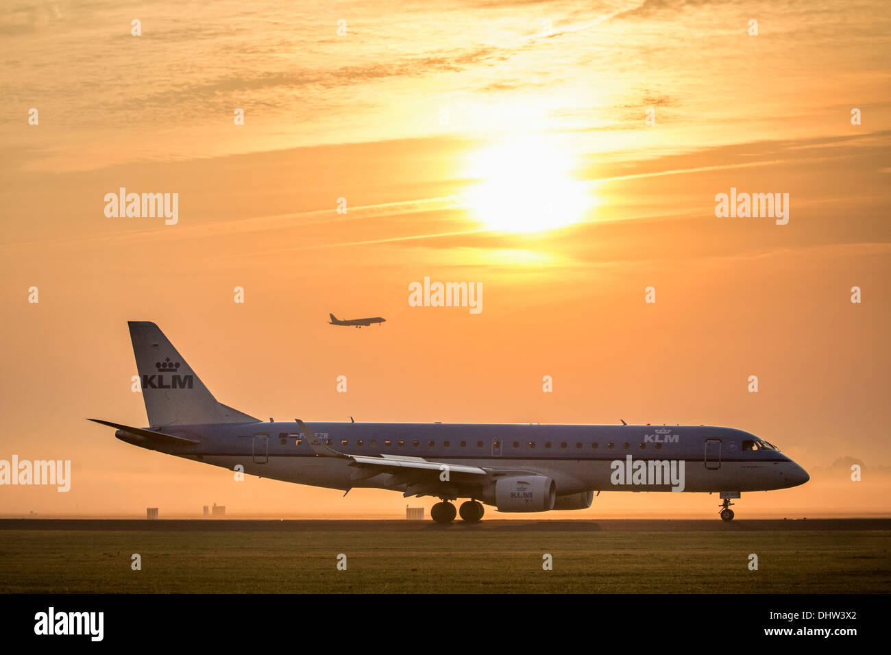 Netherlands, Vijfhuizen, Amsterdam Schiphol Airport. Runway called Polderbaan. KLM airplane landing. Sunrise Stock Photo