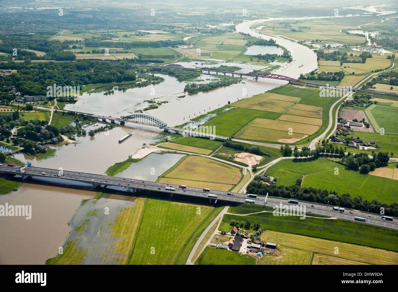 Netherlands, Deventer, Bridges over IJssel river. Cargo boats. Flooded ...