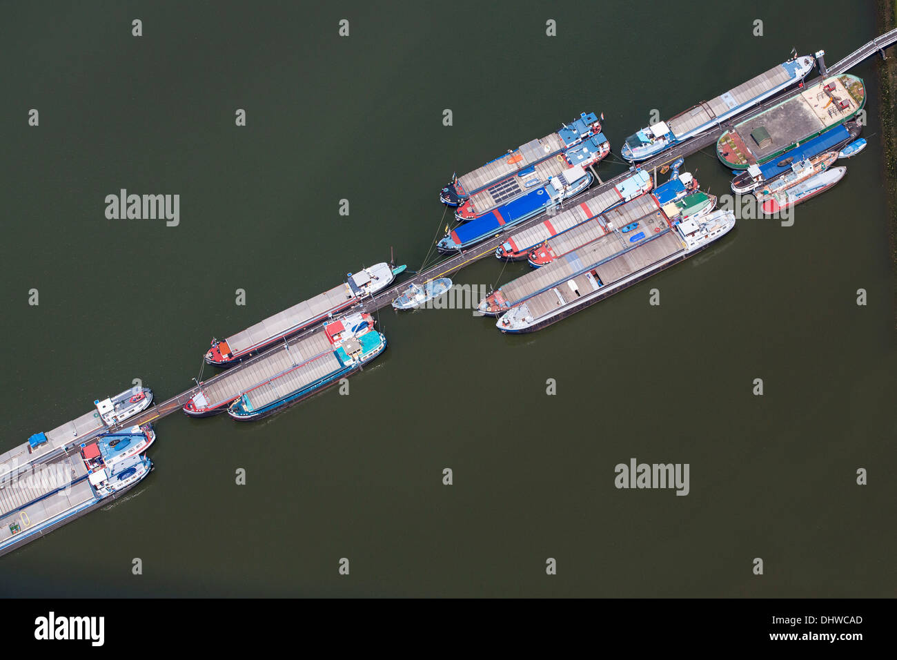 Netherlands, Rotterdam, Inland barges waiting for load. Aerial Stock Photo