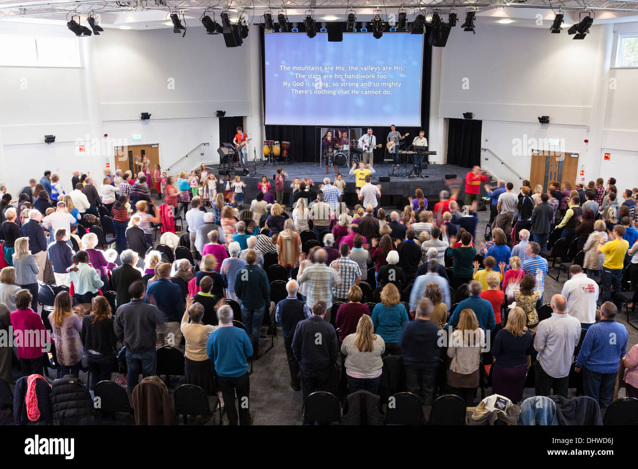 Congregation participating in contemporary worship music during Sunday Service inside the large modern Kings Community Church. Stock Photo