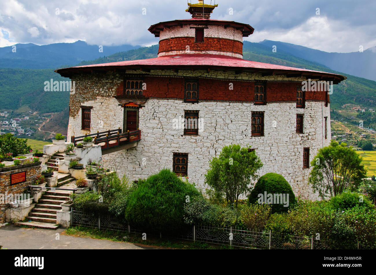 Paro,main street,traditional architecture,richly decorated buildings housing small shops surrounded by farms rice paddies,Bhutan Stock Photo