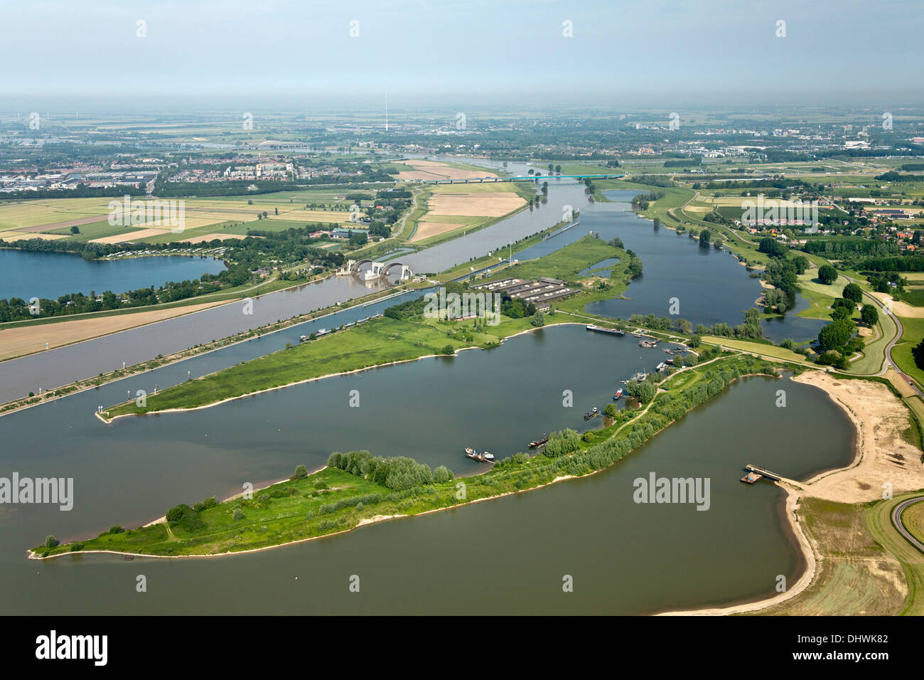 Netherlands, Hagestein. Weir and lock complex in Lek river. Flooded flood plains. Aerial Stock Photo