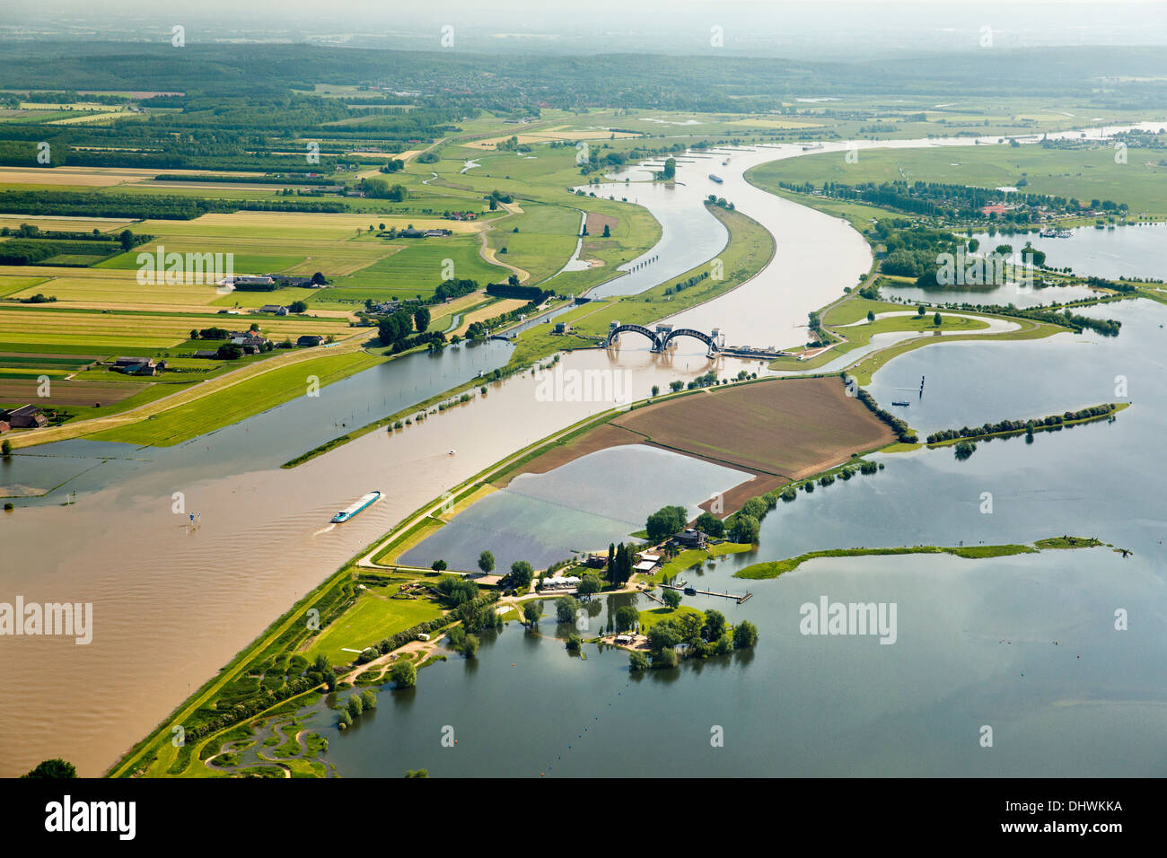Netherlands, Amerongen. Weir and lock complex in Nederrijn river. Cargo boat. Flooded flood plains. Aerial Stock Photo