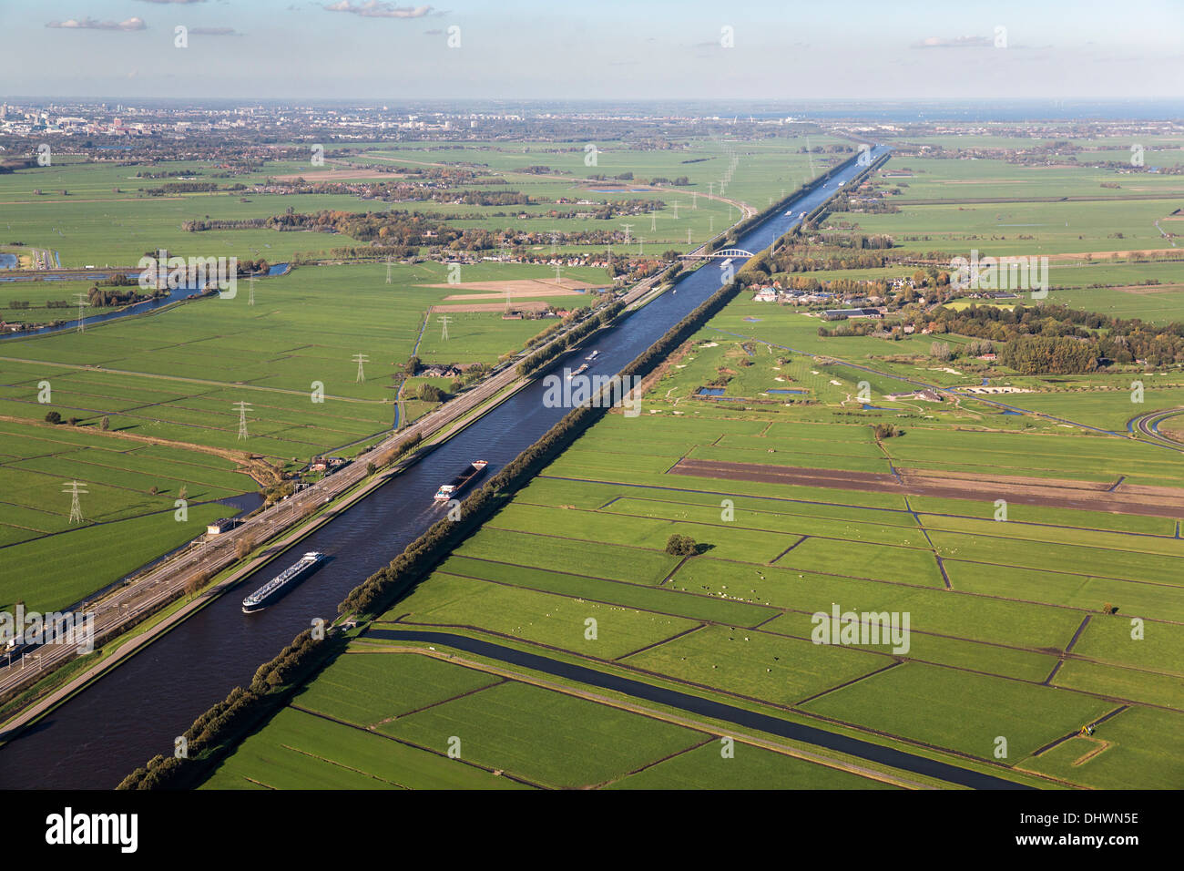 Netherlands, Loenersloot, Cargo ships on canal called Amsterdam-Rijnkanaal. Aerial Stock Photo
