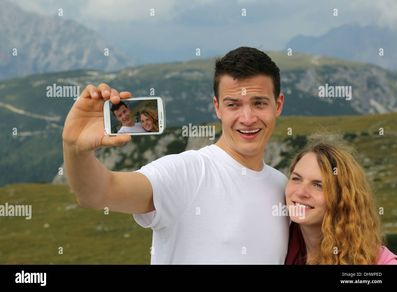 Young couple taking pictures with a smartphone as a memory on the holiday Stock Photo
