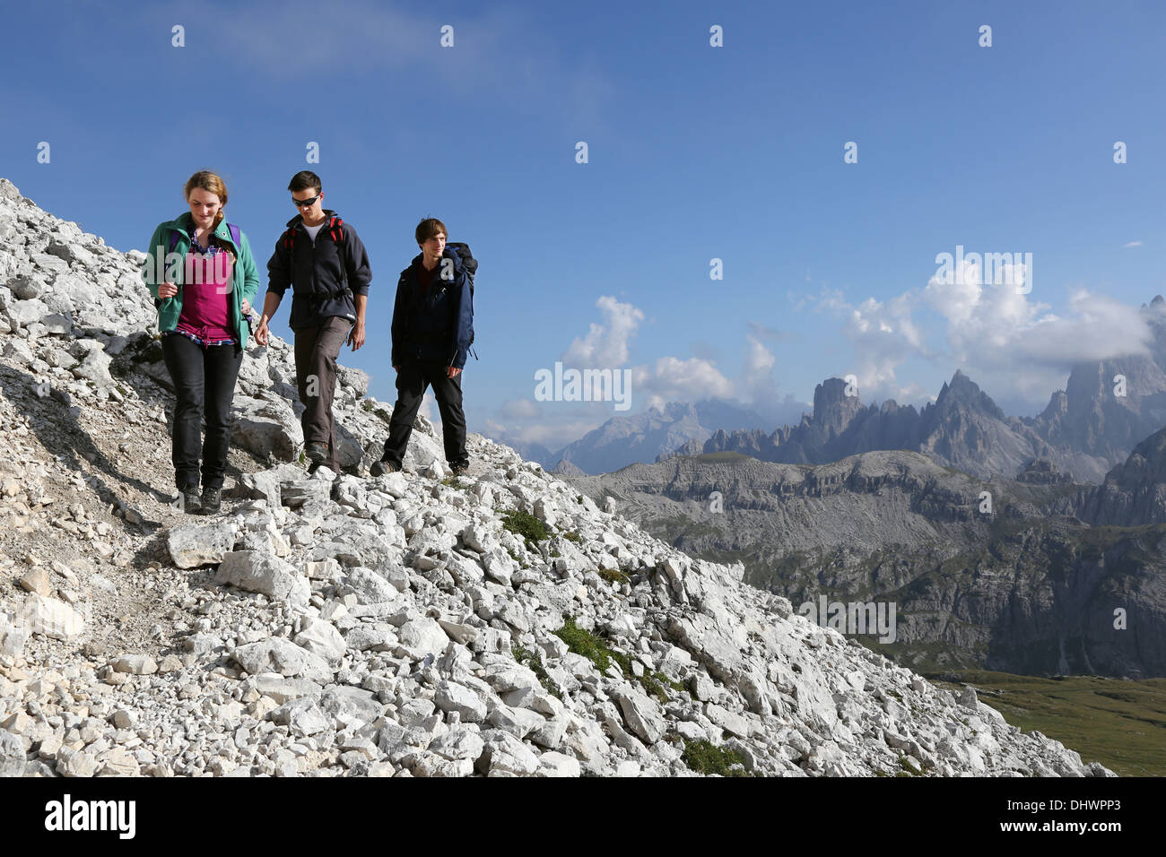 Group of young people hiking in the mountains Alps Dolomites Stock ...