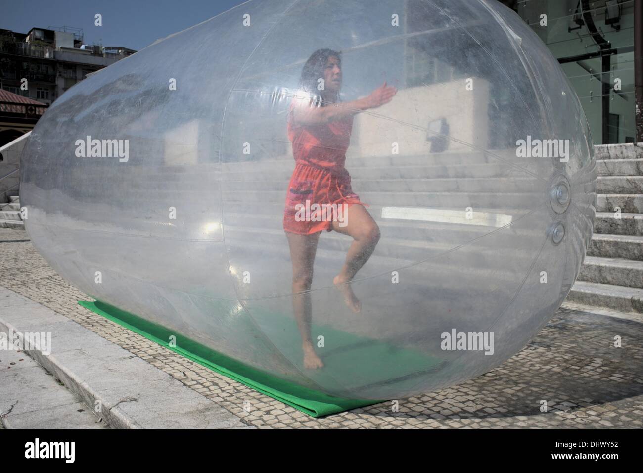 Girl marching inside bubble at Macau Fringe Festival Stock Photo