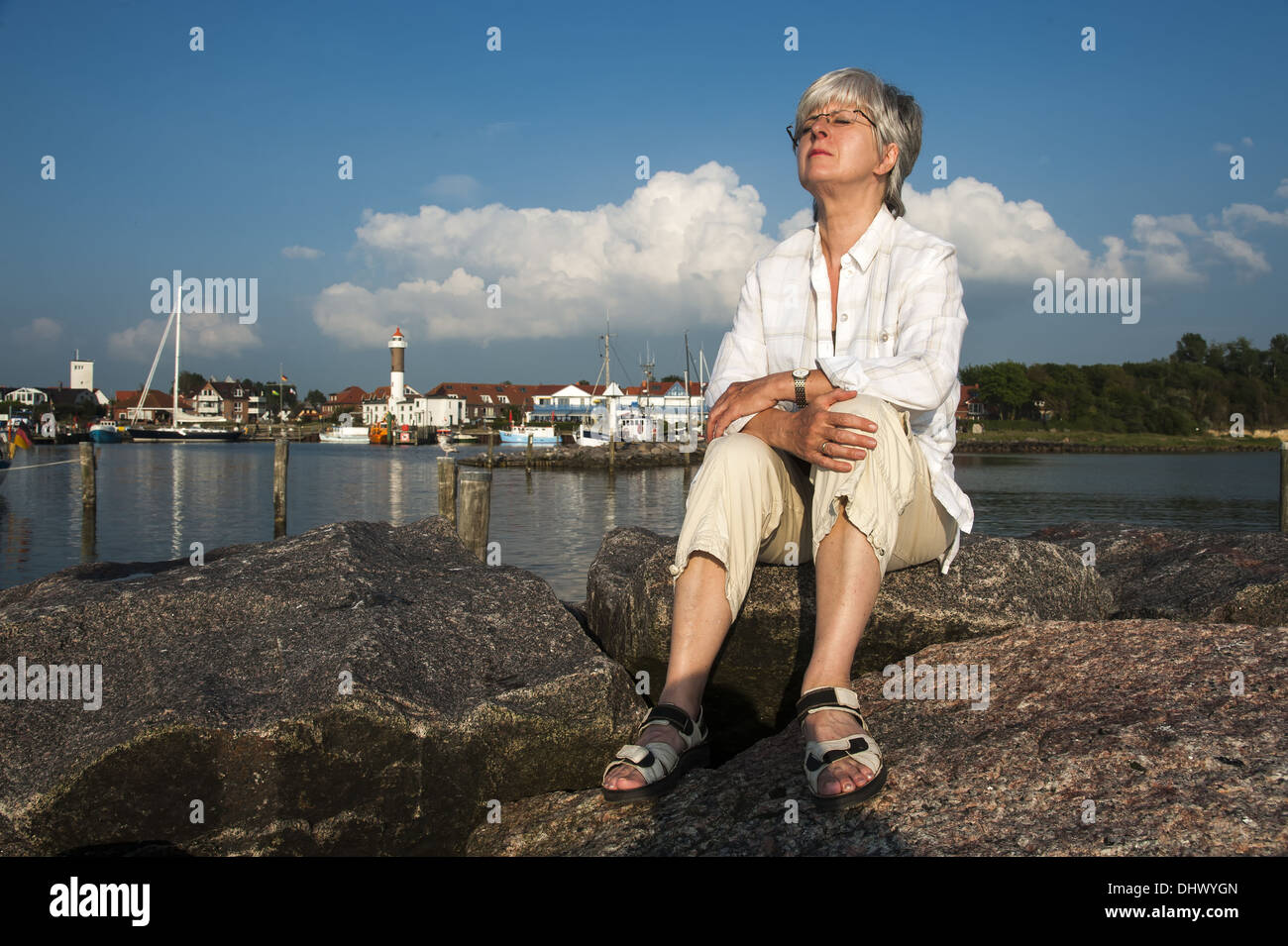 Woman sitting on the pier Stock Photo