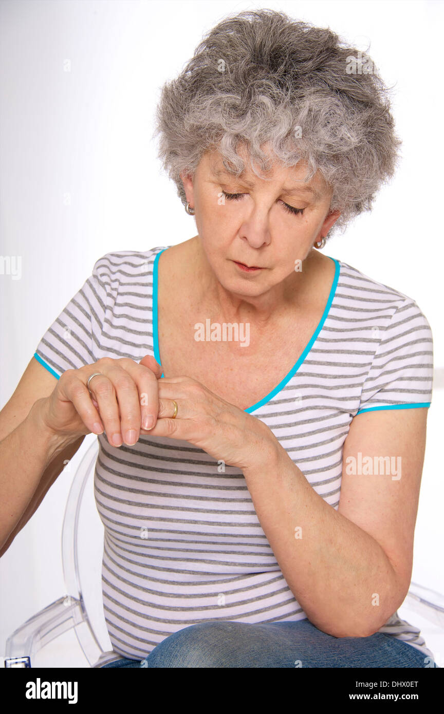 ELDERLY PERS. WITH PAINFUL HAND Stock Photo