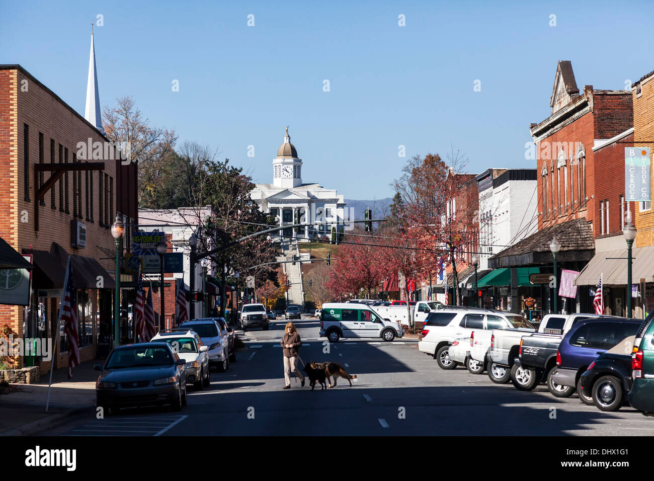 Woman walking two dogs across Main Street in Sylva, a small Smoky