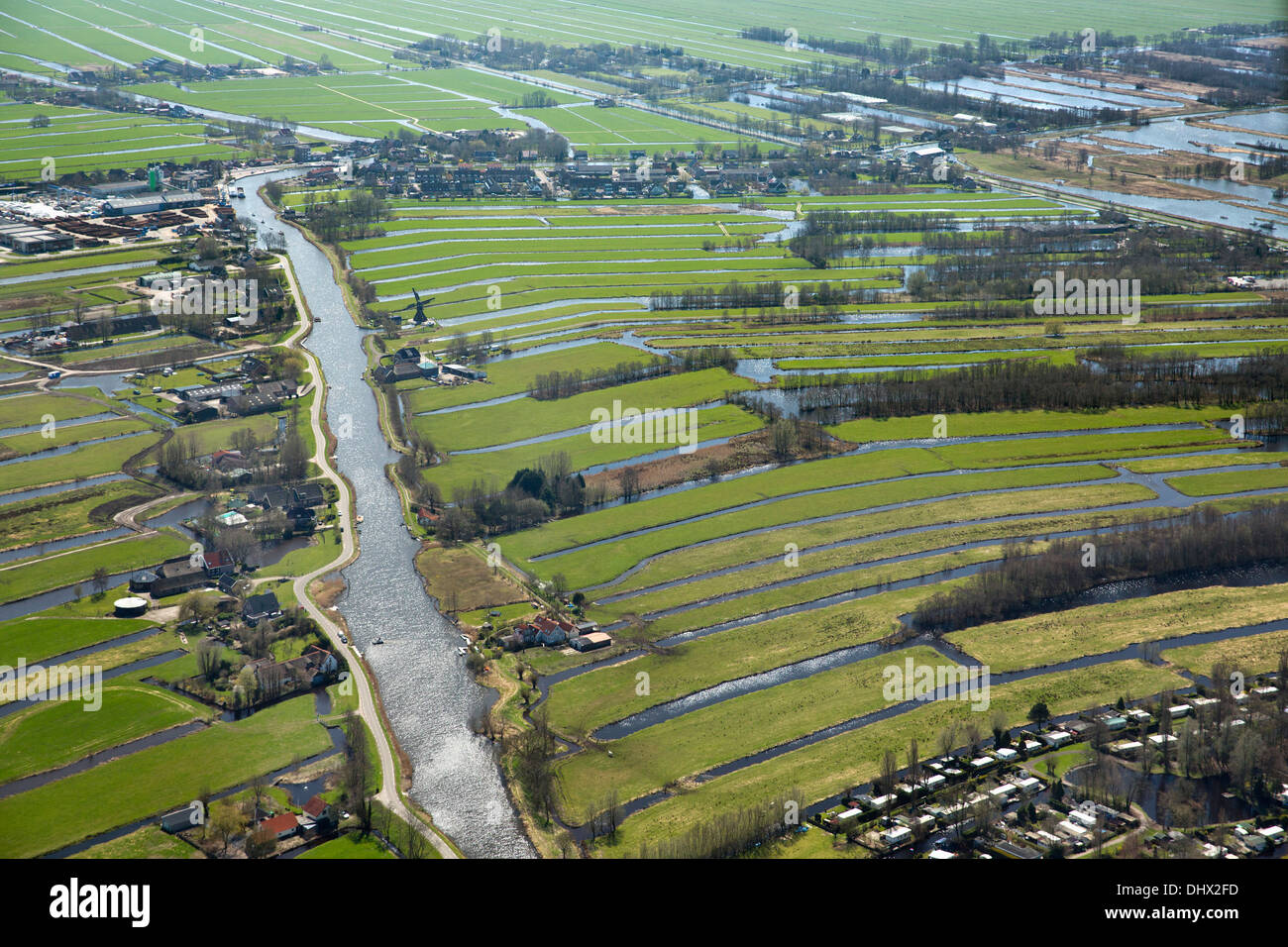 Netherlands, Nieuwkoop, Farms, farm land, windmill near lakes called Nieuwkoopse Plassen. Aerial