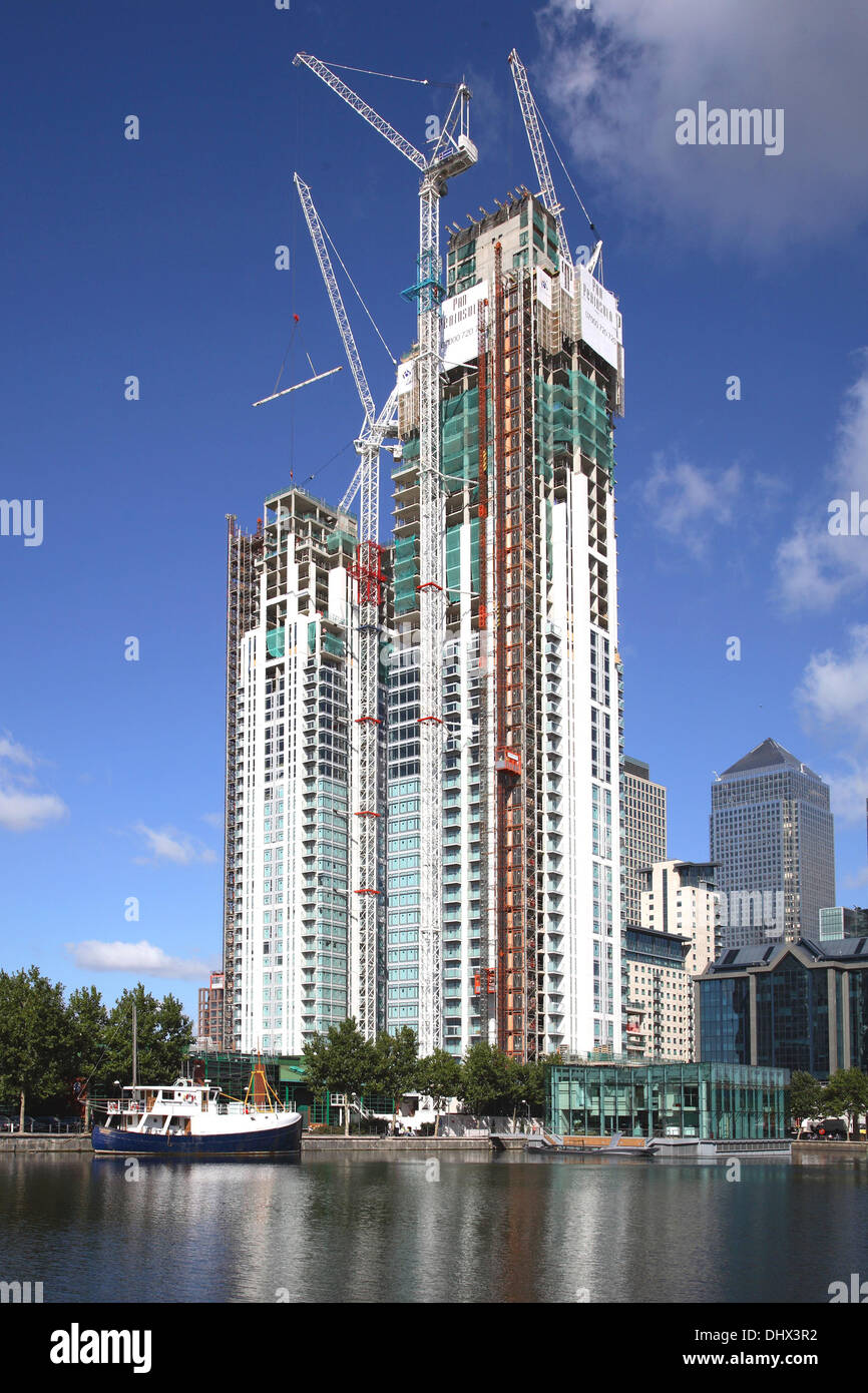 Twin towers of the Pan Peninsular residential development under construction in London's Docklands. Canary Wharf in background. Stock Photo