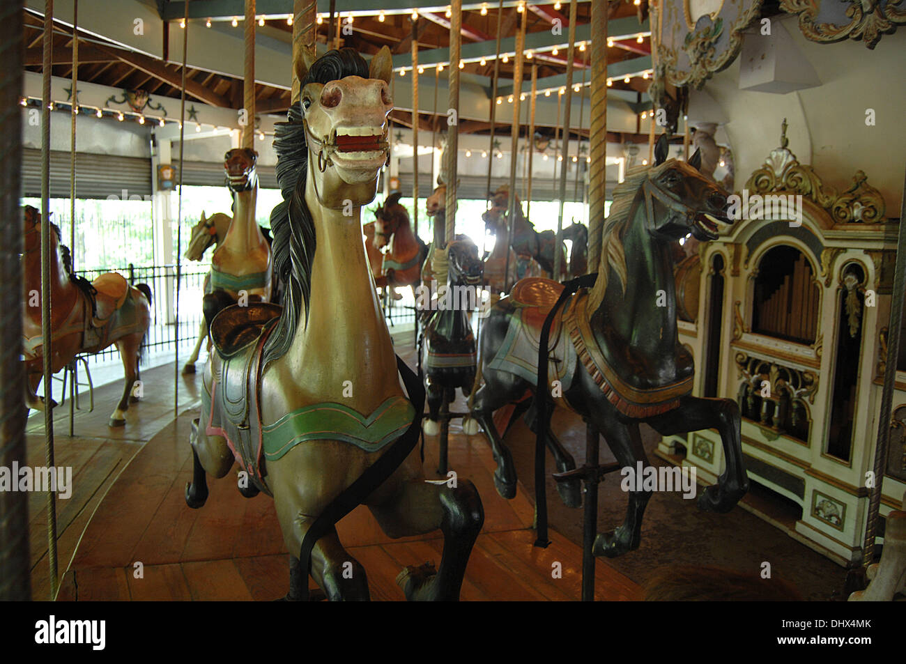 The Forest Park Carousel, a 1910 merry-go-round hidden away in the woods in Woodhaven, Queens, has now received NYC landmark status. The carousel, which features a colorful menagerie of 46 hand-carved horses, as well as a lion, tiger and deer, was unanimously declared a landmark by the Landmarks Preservation Commission on Tuesday (260613).  Where: Queens, New York, United States Wh Stock Photo