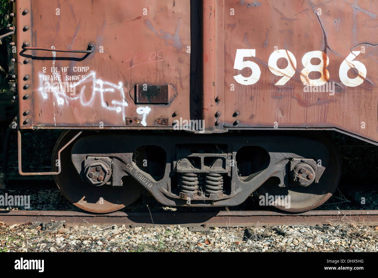 Wheels and suspension of unused railroad train freight car stored on a side spur near Dillsboro and Sylva, North Carolina, USA. Stock Photo