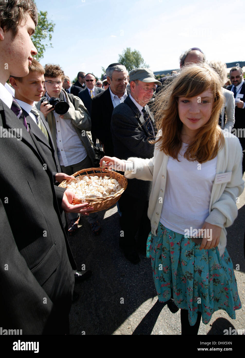 Polish boys from Brzostek Poland offering garlic during the reconsecration Brzostek's Jewish
