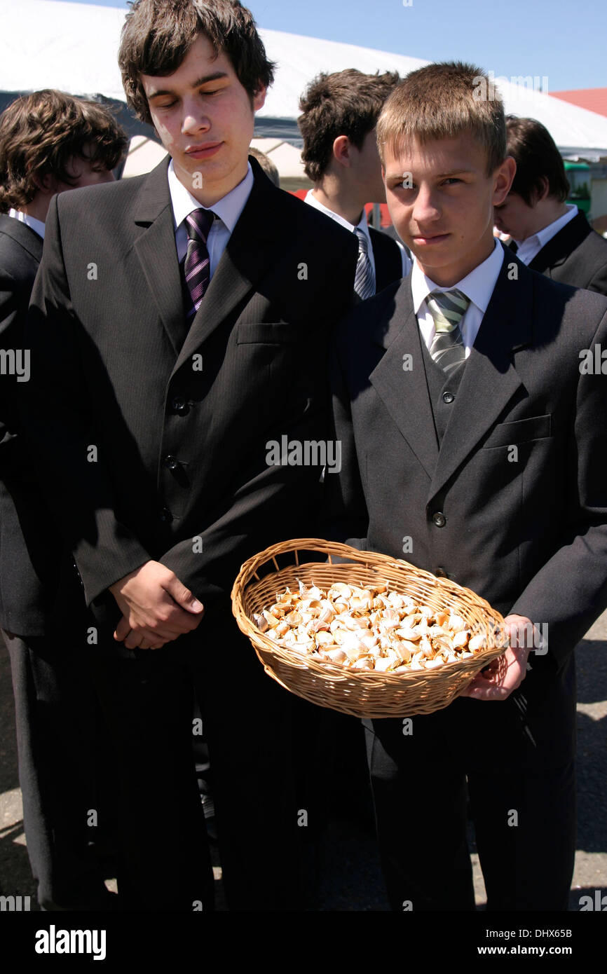 Polish boys from Brzostek Poland offering garlic during the Stock Photo