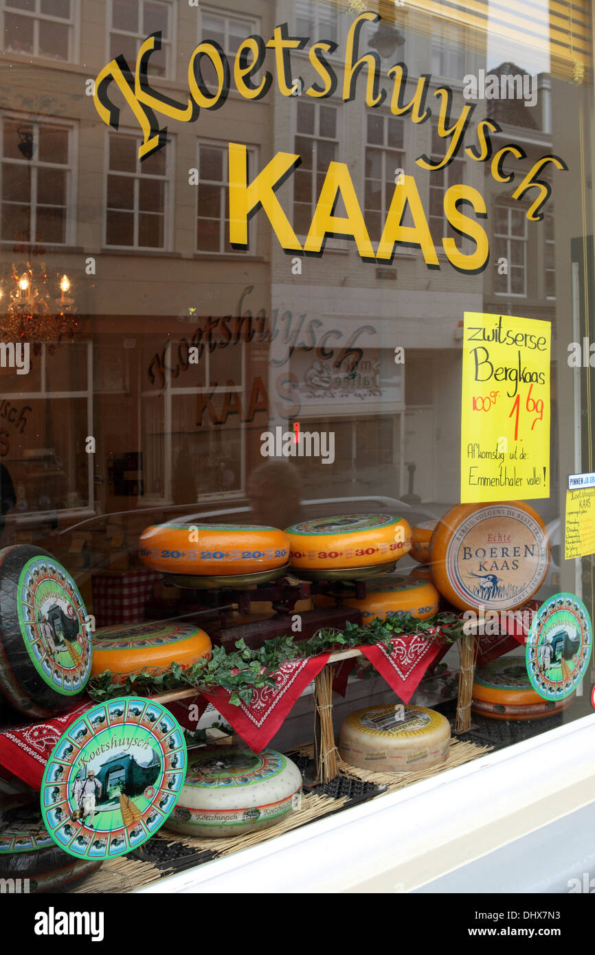 Window of a Dutch cheese shop in 's-Hertogenbosch in the Netherlands. The window holds wheels of Dutch cheese. Stock Photo