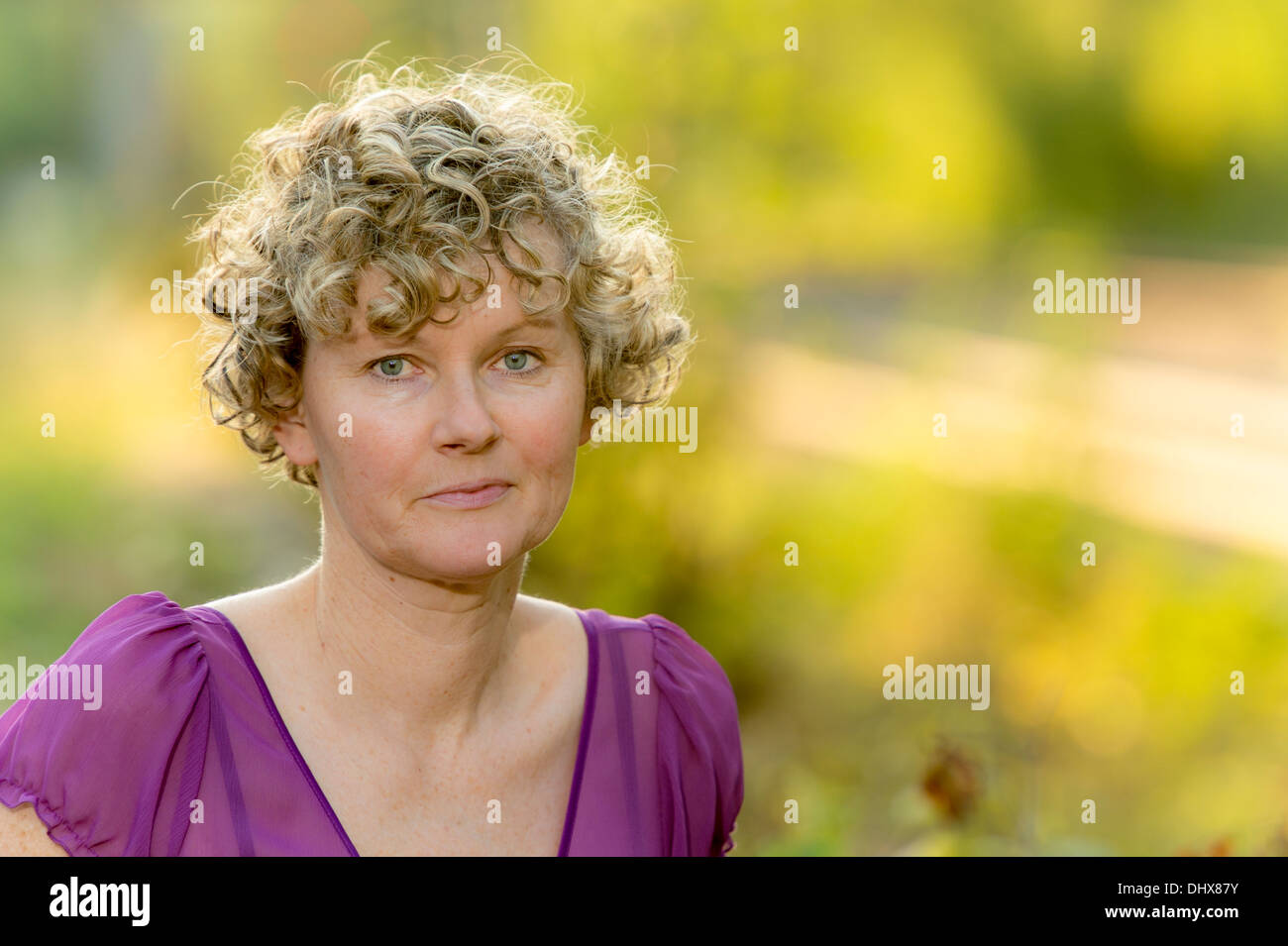 Woman Middle Aged Curly Hair During Sunset Stock Photo