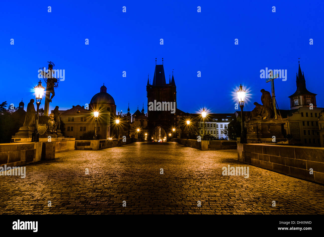 Night over Charles bridge with its statuette and the roofs of the old building, Prague, Bohemia, Czech Republic Stock Photo