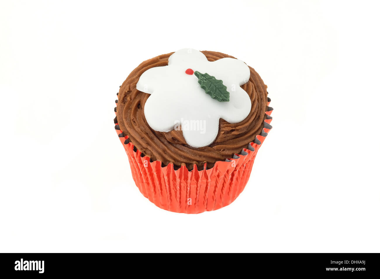 A cupcake with a decorated Christmas design of a Christmas pudding - studio shot with a white background Stock Photo