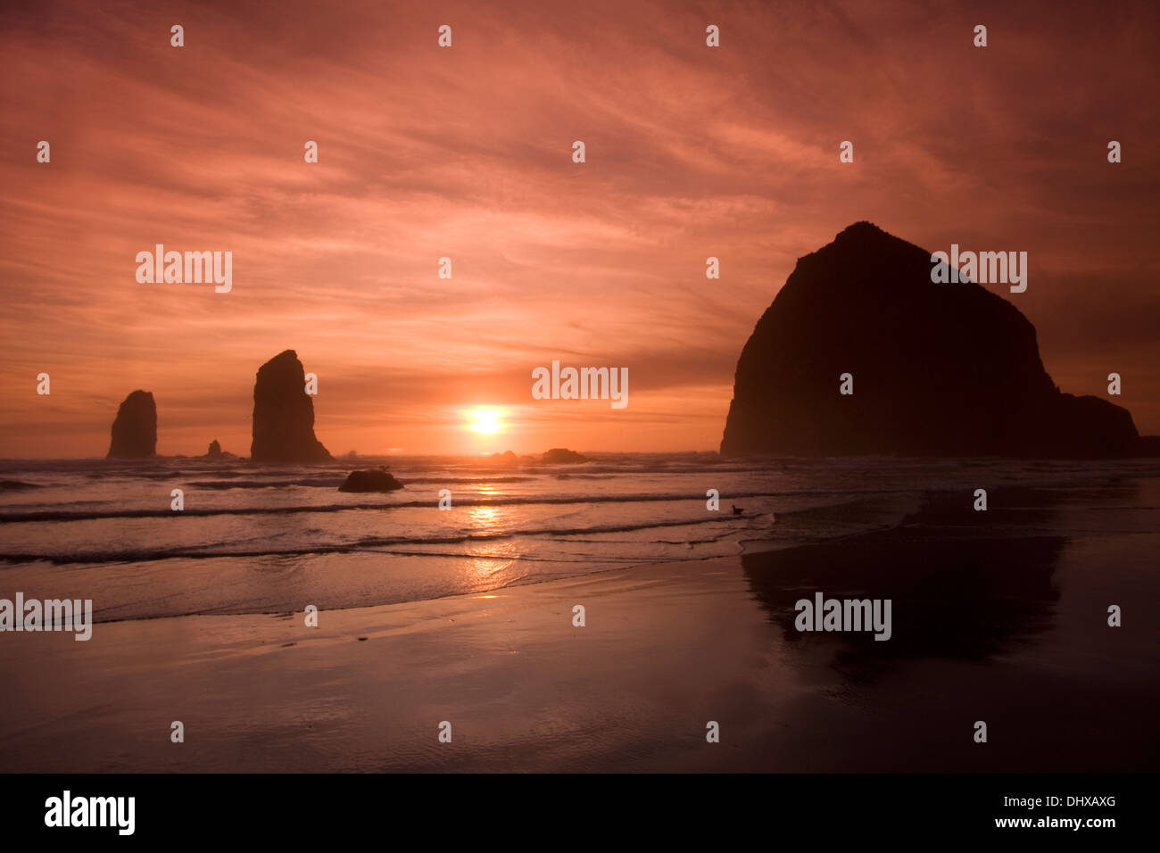 Sunset on Haystack Rock from Canon Beach, Oregon. Stock Photo