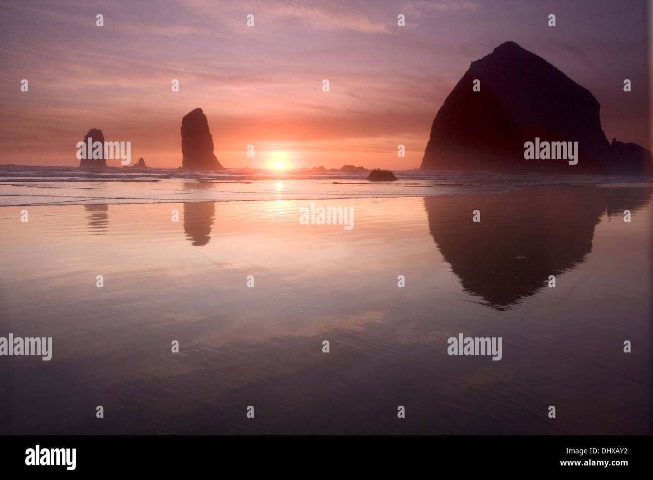 Sunset over Haystack Rock at Canon Beach, Oregon. Stock Photo