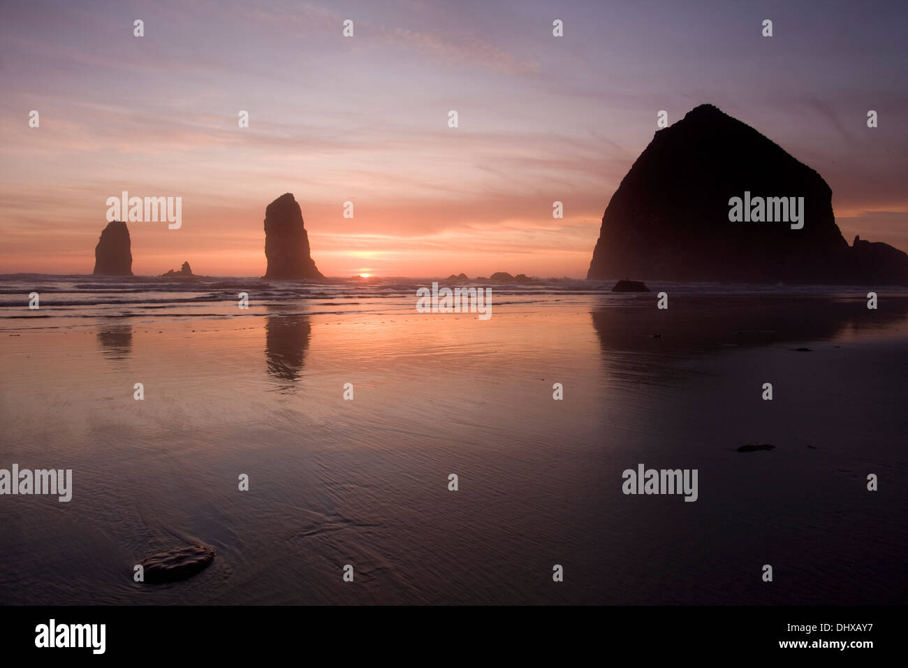 Sunset over Haystack Rock at Cannon Beach, Oregon. Stock Photo