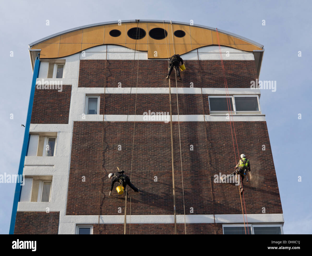 Workers cleaning the walls of a council housing estate in Hackney, London, UK Stock Photo