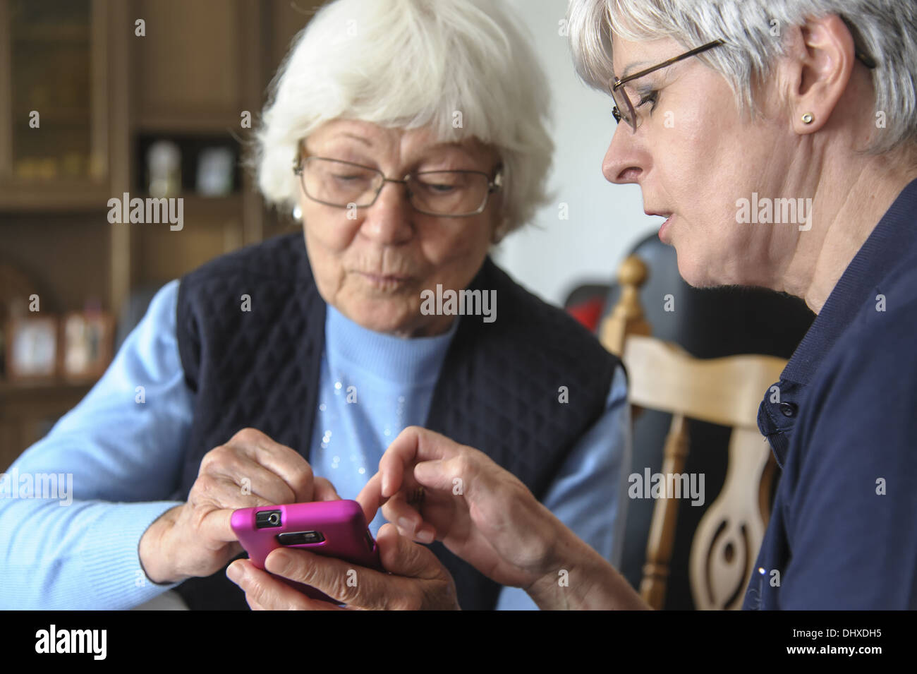 2 gray-haired senior with a smartphone Stock Photo