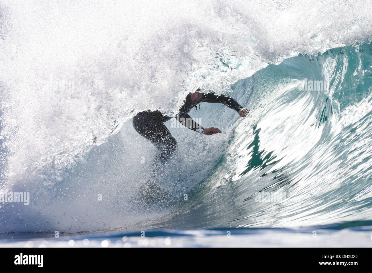 A surfer rides a silver tube at Big Rock in La Jolla, California. Stock Photo
