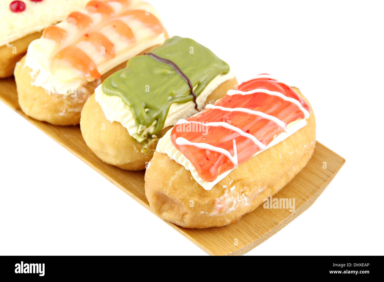Donuts sort in the bamboo dish on white background. Stock Photo