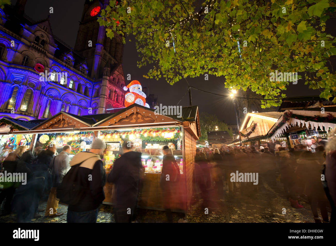 Manchester, UK. 15th November, 2013. Thousands of visitors flock to the 300 Christmas Market stalls spread across various locations in Manchester city centre. This is the 15th year that the Christmas Market has come to town, and is the biggest in Britain. The Markets are located in Corporation Street, King Street and Exchange Square, though the largest is in Albert Square, in front of the town hall. Credit:  Russell Hart/Alamy Live News (Editorial use only). Stock Photo