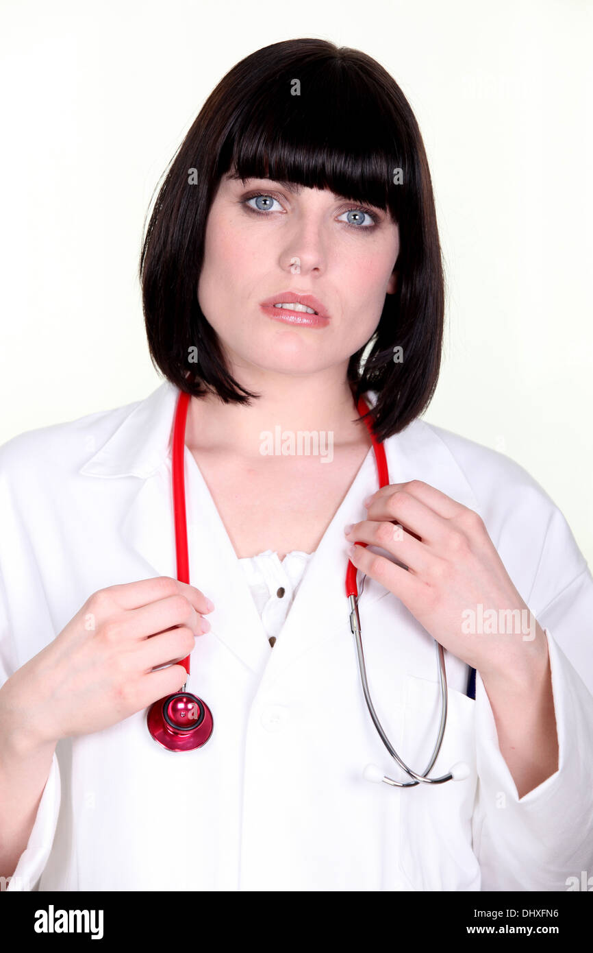 Worried doctor with a stethoscope around her neck Stock Photo