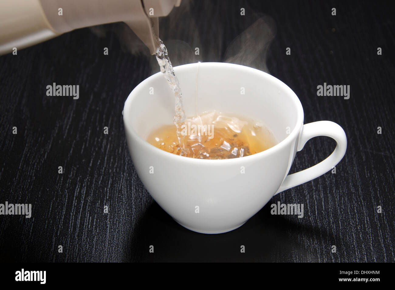 Pouring water for your tea cup Stock Photo