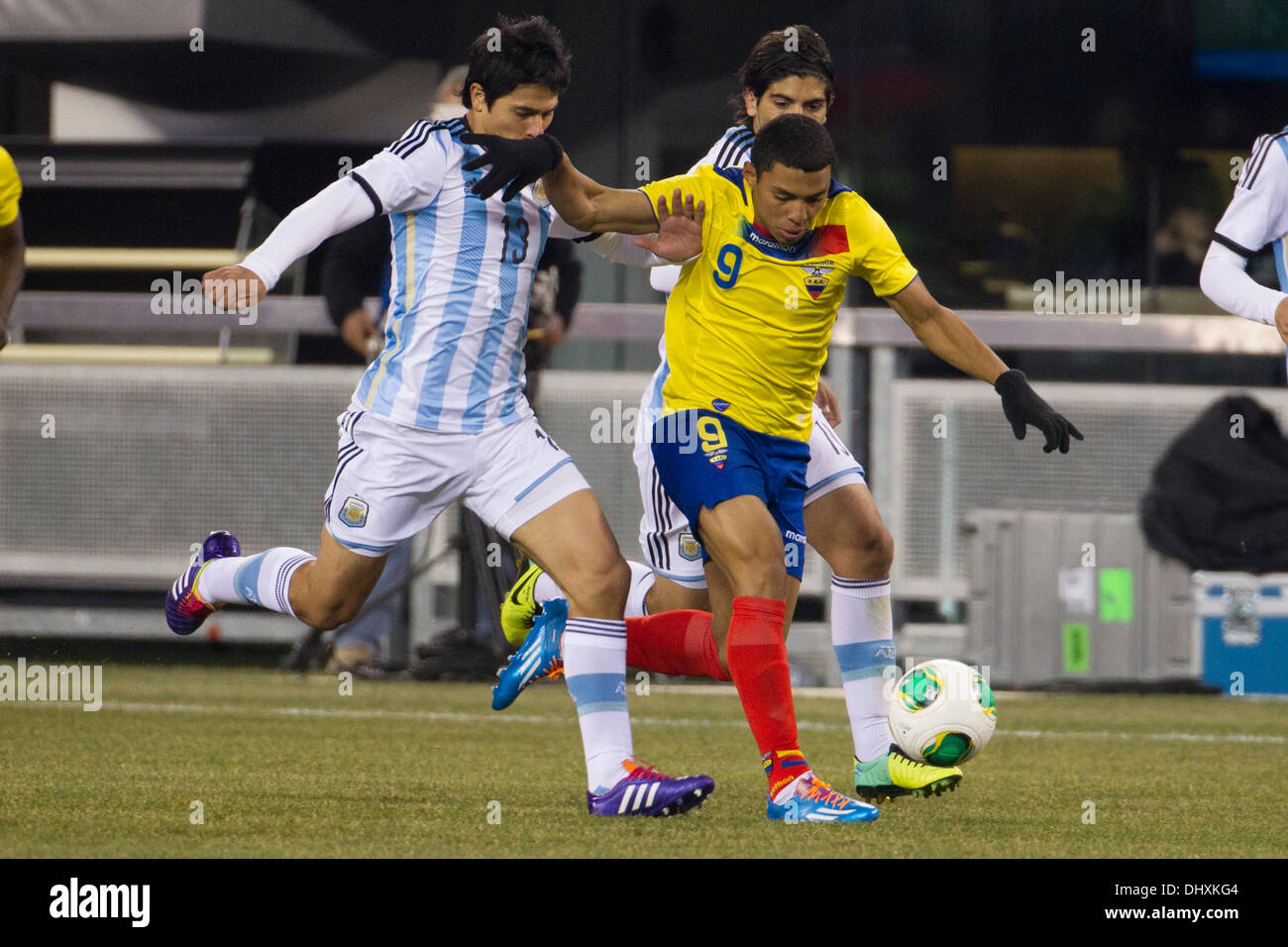 a tie, 0-0, . 15th Nov, 2013. Ecuador midfielder Jefferson Montero (9) drives up the field with the ball as he is flanked by Argentina defender Facundo Roncaglia (13) and midfielder Ever Banega (19) during the Gillette International Soccer series game between Argentina and Ecuador at the MetLife Stadium in East Rutherford, New Jersey. The match ends in a tie, 0-0. (Christopher Szagola/Cal Sport Media) © csm/Alamy Live News Stock Photo