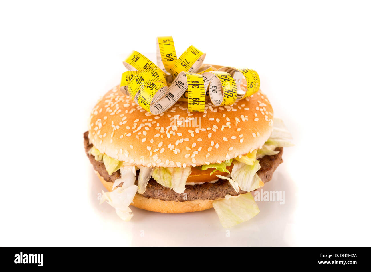 Measuring tape on the top of an appetizing hamburguer - diet concept ...