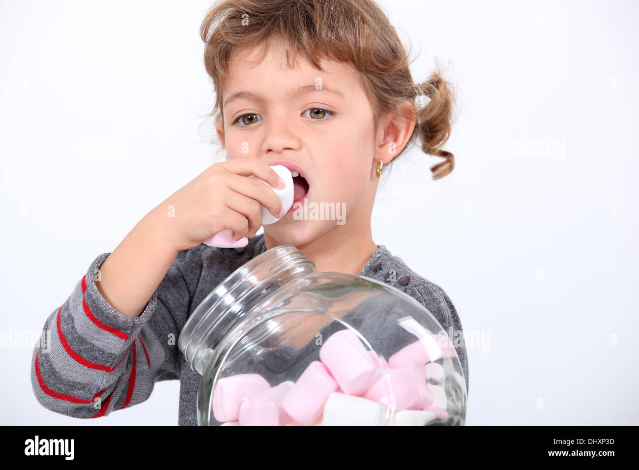 Little girl eating marshmallow Stock Photo Alamy