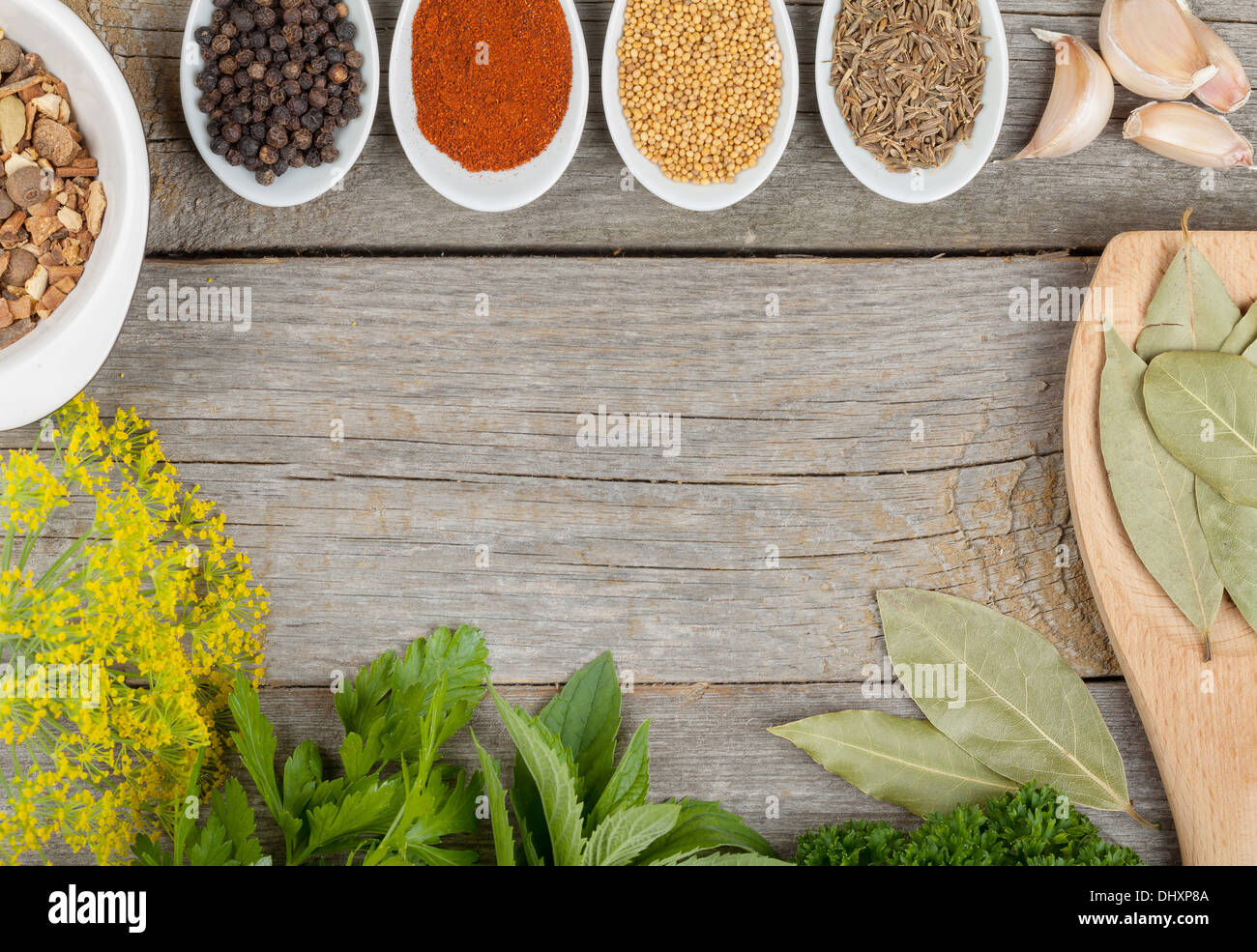 Colorful herbs and spices selection. Aromatic ingredients on wood Stock
