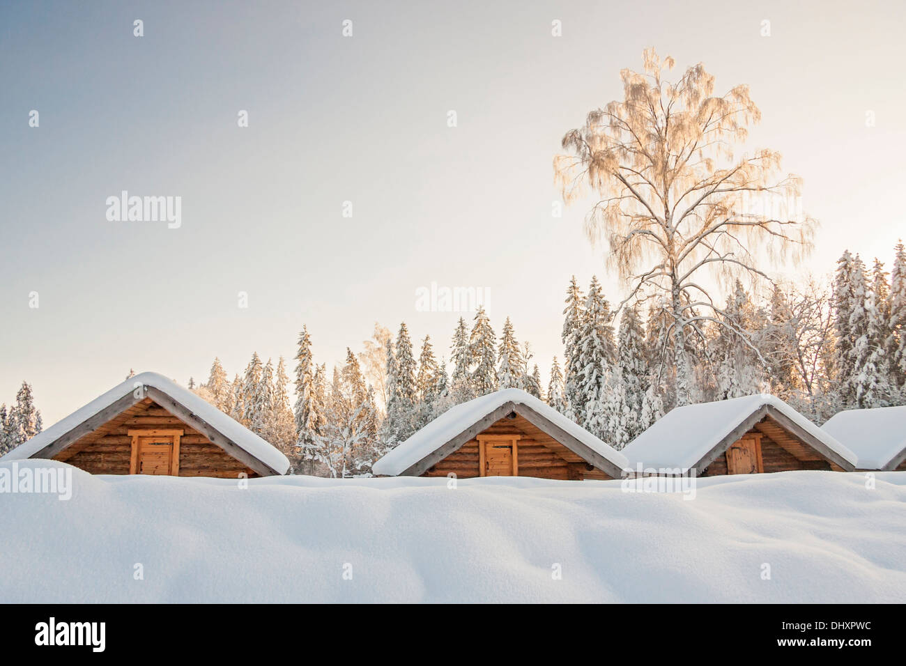 Small Snowy Cosy Log Cabins In Row At Very Snowy Winter Day Stock