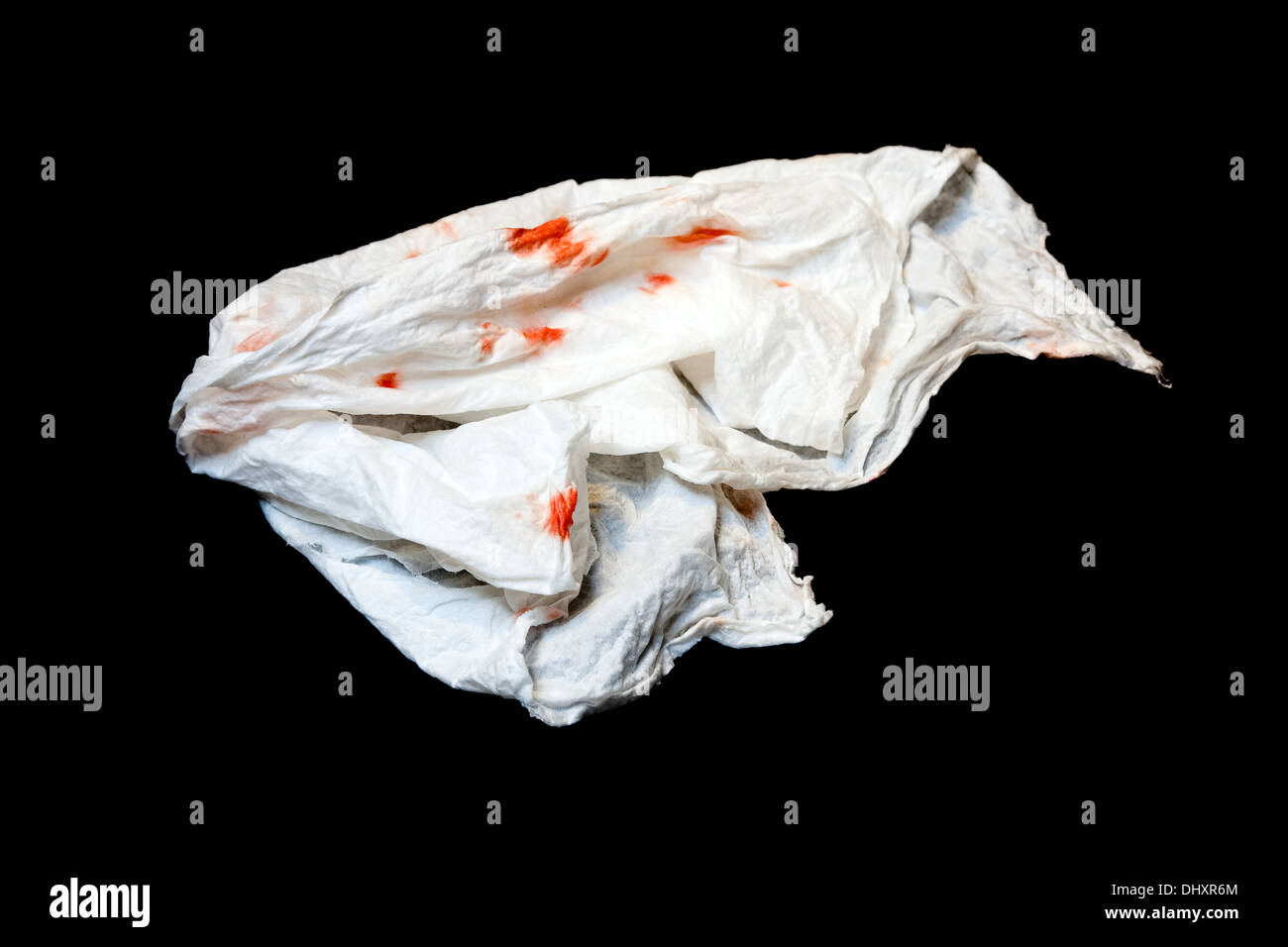 Isolated white used tissue with blood spots due to heavy sniffle Stock Photo