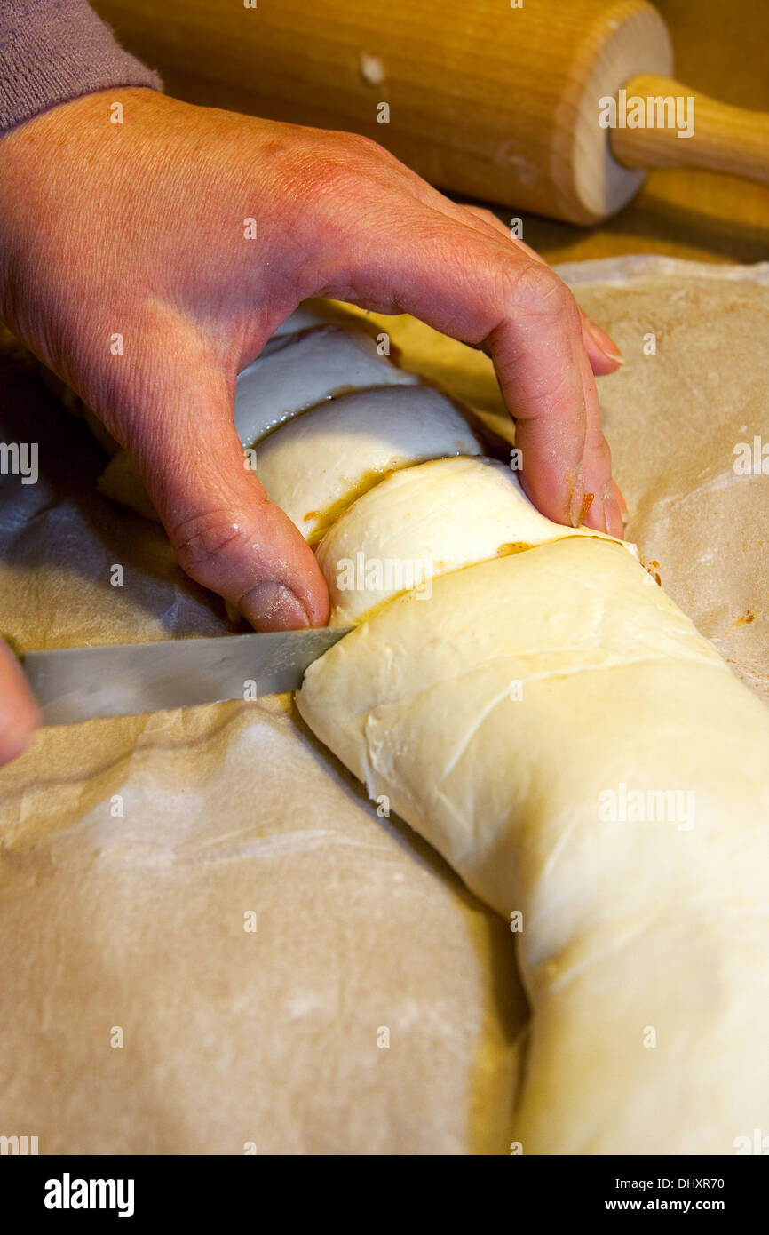 Baker cutting raw pies with knife Stock Photo Alamy