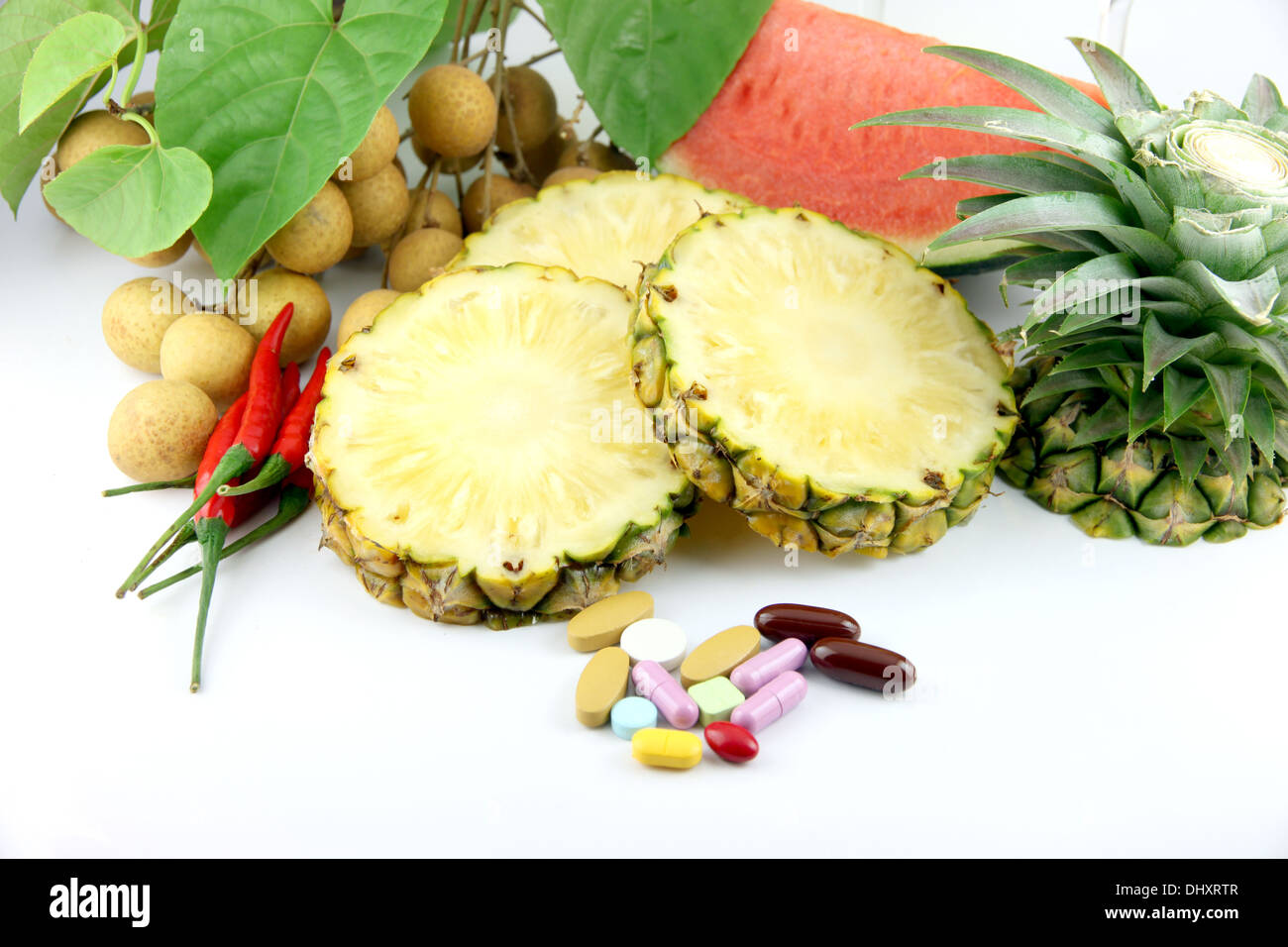 Fruits and medicines placed on white background. Stock Photo