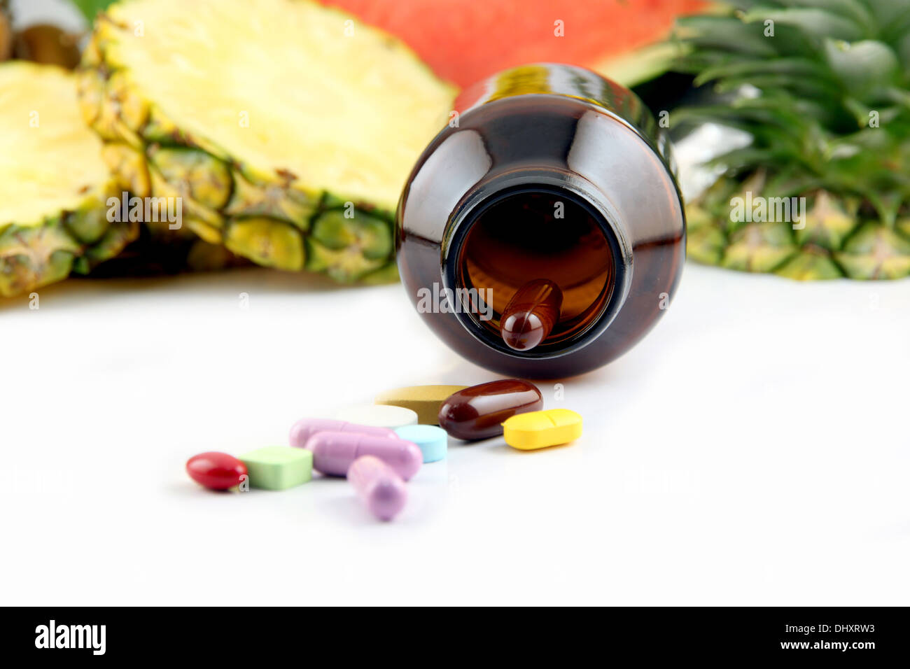 Fruits and medicines placed on white background. Stock Photo