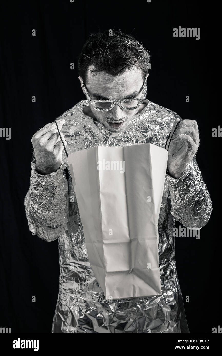 Surprised alien man looking at shopping bag. Stock Photo